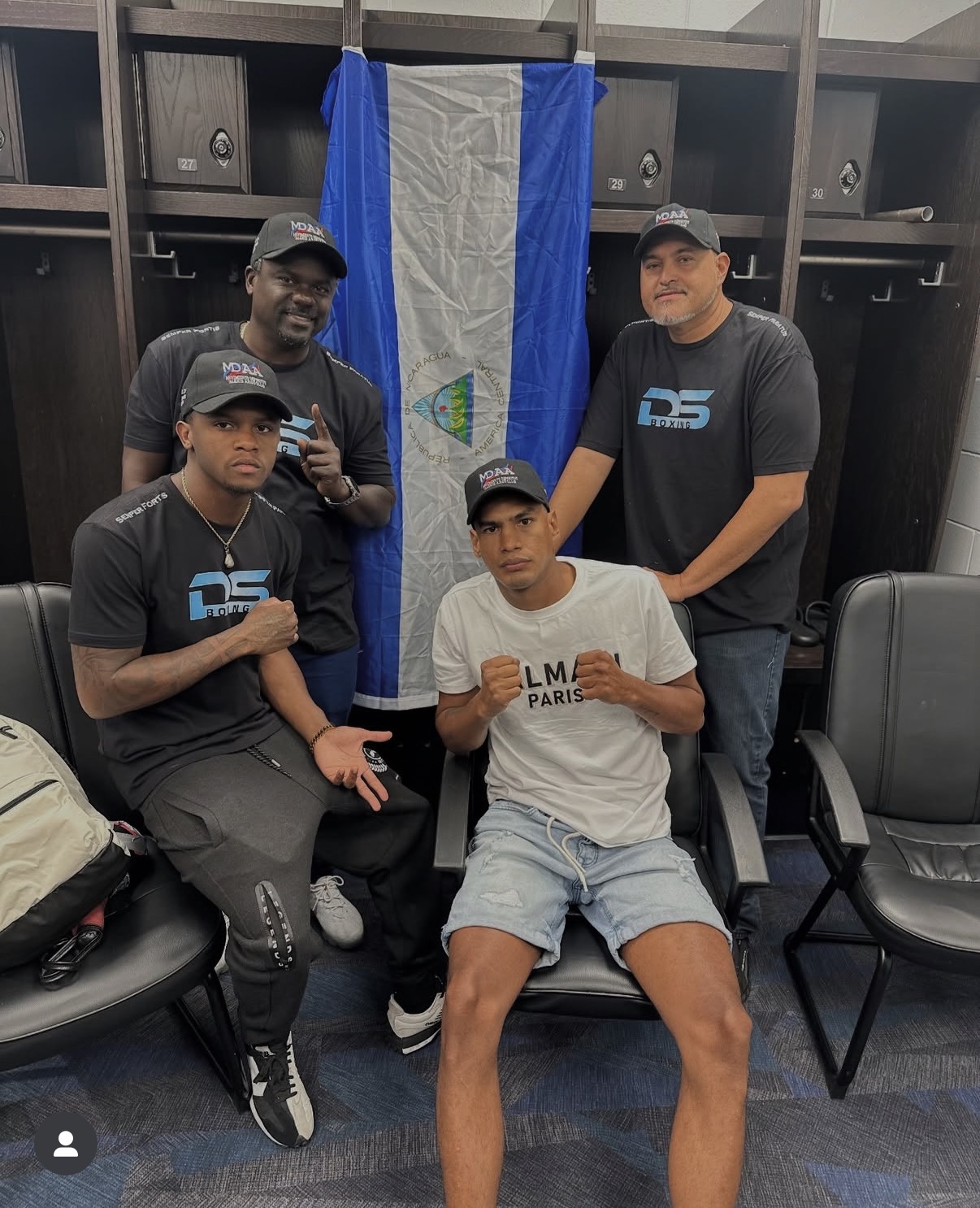 Coach Derik Santos with the DS Boxing team and fighters in the locker room before a fight